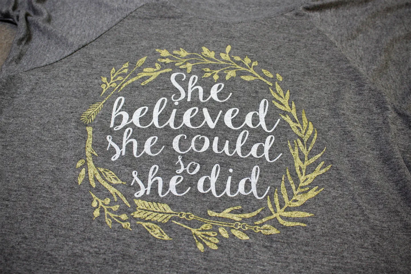 "She Believed She Could, So She Did" design printed on a Flowy Raglan Tee